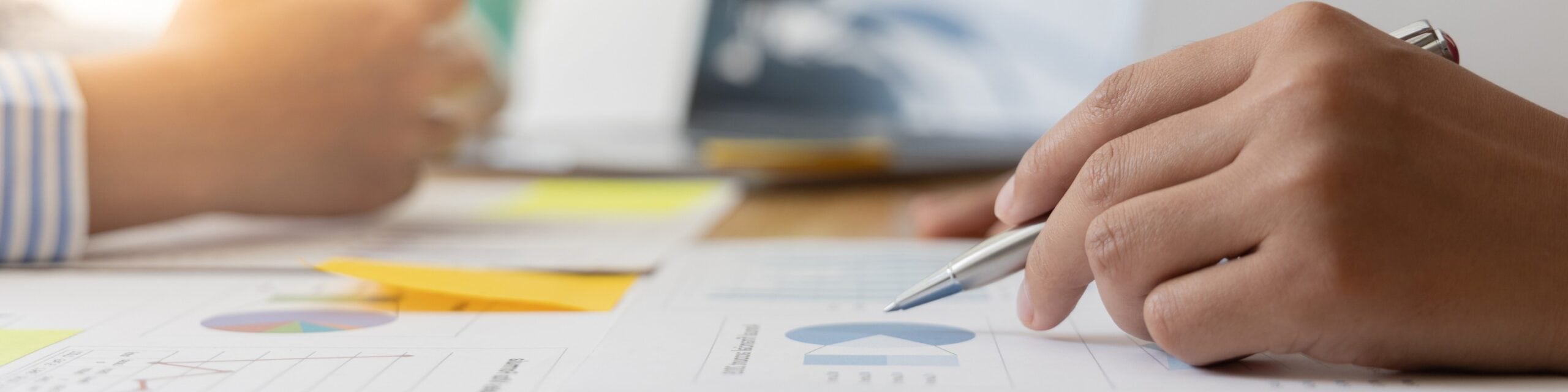 A person is writing on a piece of paper with a pen.