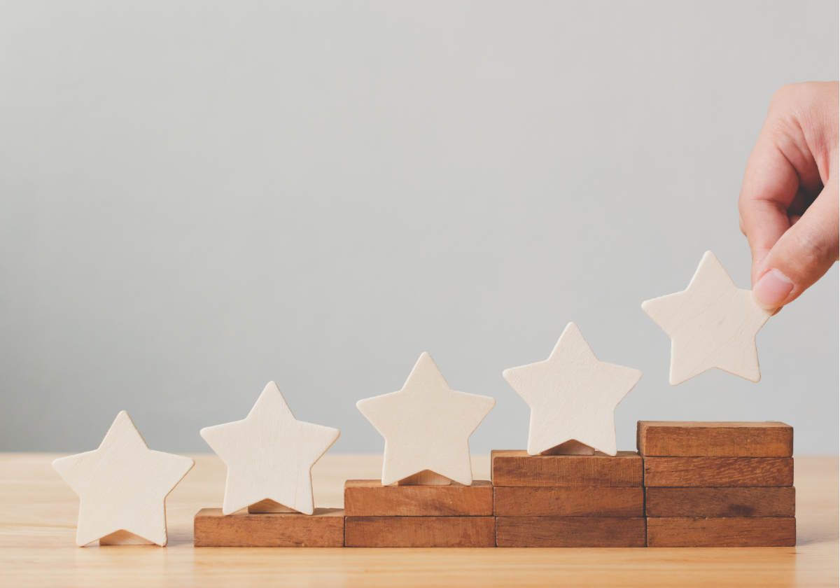 A person is placing wooden stars on a wooden board.